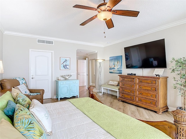 4071 S Atlantic Ave Unit 803, New Smyrna Beach, FL 32169 - bedroom with crown molding, light wood-style flooring, baseboards, ceiling fan, and a textured ceiling