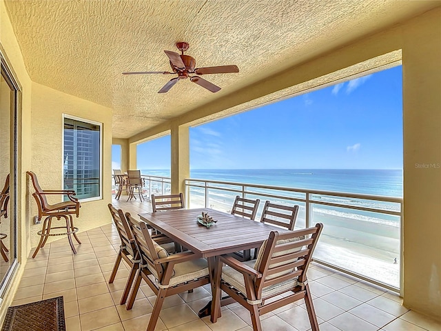 4071 S Atlantic Ave Unit 803, New Smyrna Beach, FL 32169 - balcony featuring ceiling fan, view of water and beach, and outdoor dining space