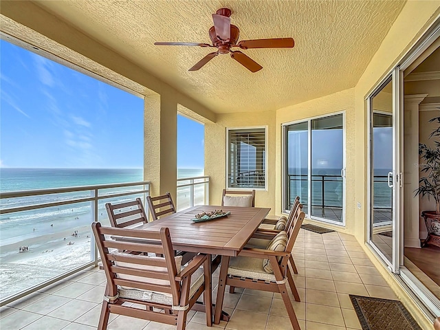 4071 S Atlantic Ave Unit 803, New Smyrna Beach, FL 32169 - sunroom / solarium featuring tile patterned flooring, a textured ceiling, a water view, healthy amount of natural light, and a textured wall