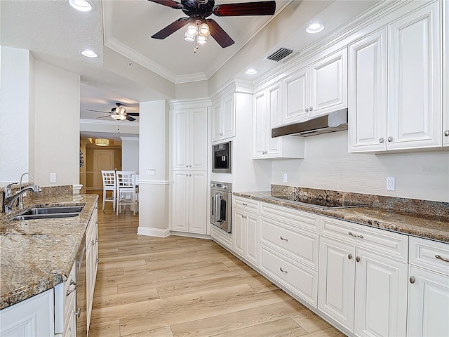 4071 S Atlantic Ave Unit 803, New Smyrna Beach, FL 32169 - kitchen featuring a ceiling fan, stainless steel oven, black electric cooktop, a sink, and under cabinet range hood