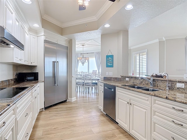 4071 S Atlantic Ave Unit 803, New Smyrna Beach, FL 32169 - kitchen featuring black appliances, ornamental molding, a sink, light wood-style floors, and healthy amount of natural light