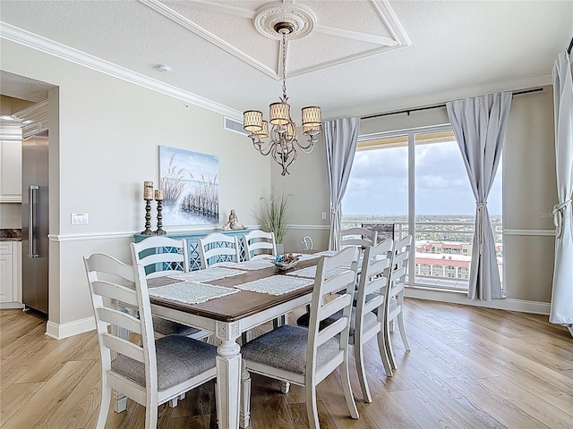 4071 S Atlantic Ave Unit 803, New Smyrna Beach, FL 32169 - dining area featuring a chandelier, light wood finished floors, ornamental molding, a textured ceiling, and baseboards