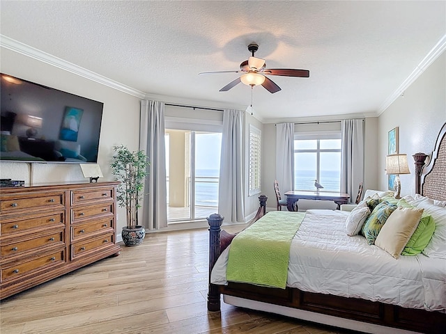 4071 S Atlantic Ave Unit 803, New Smyrna Beach, FL 32169 - bedroom featuring crown molding, light wood-style floors, access to outside, a textured ceiling, and a ceiling fan
