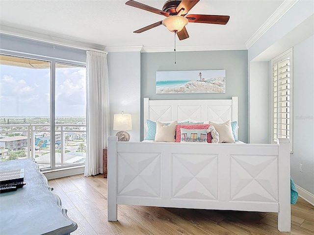 4071 S Atlantic Ave Unit 803, New Smyrna Beach, FL 32169 - bedroom featuring crown molding, wood finished floors, a ceiling fan, and access to exterior