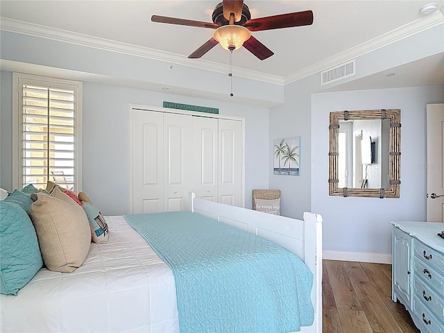 4071 S Atlantic Ave Unit 803, New Smyrna Beach, FL 32169 - bedroom with crown molding, dark wood-style flooring, a closet, baseboards, and a ceiling fan