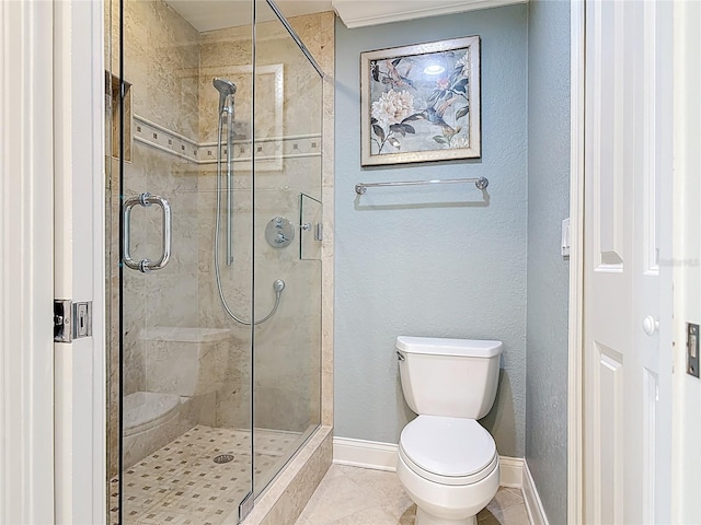 4071 S Atlantic Ave Unit 803, New Smyrna Beach, FL 32169 - full bathroom featuring toilet, a shower stall, baseboards, and tile patterned flooring