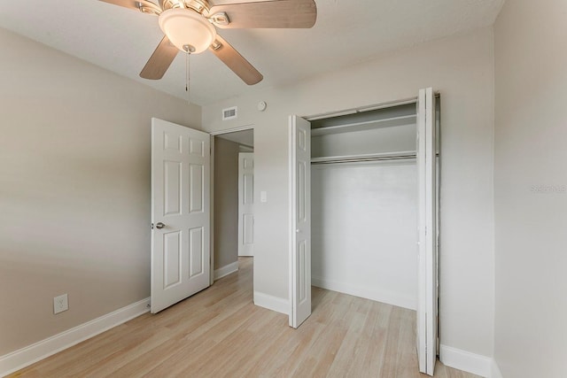 unfurnished bedroom featuring visible vents, light wood finished floors, baseboards, and a closet