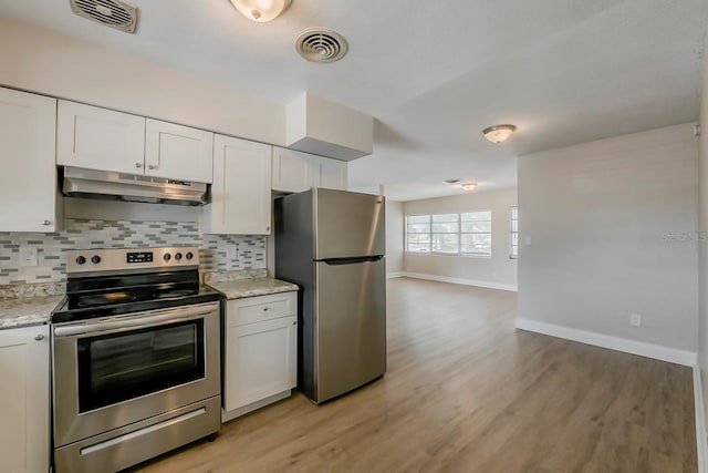 kitchen with visible vents, baseboards, appliances with stainless steel finishes, and under cabinet range hood