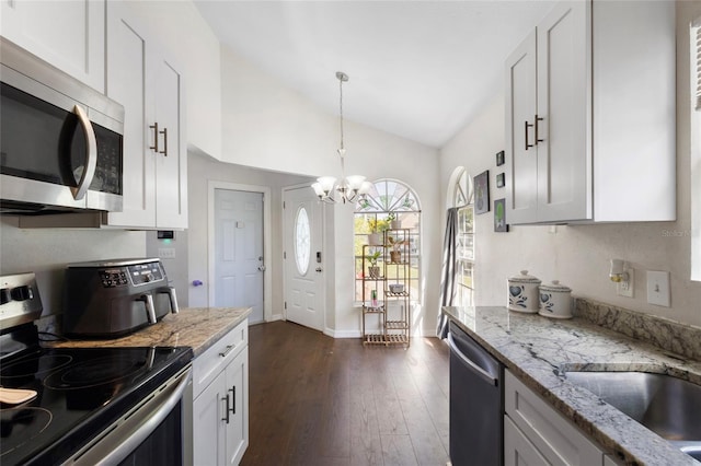 kitchen with a chandelier, appliances with stainless steel finishes, dark wood-style floors, and white cabinets