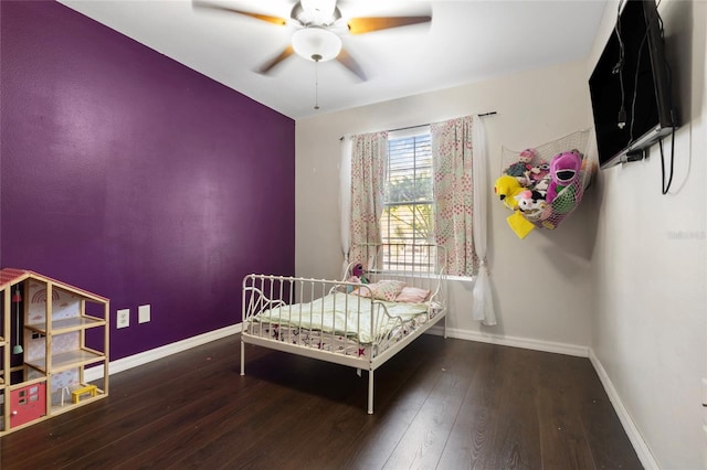 bedroom featuring hardwood / wood-style flooring, ceiling fan, and baseboards