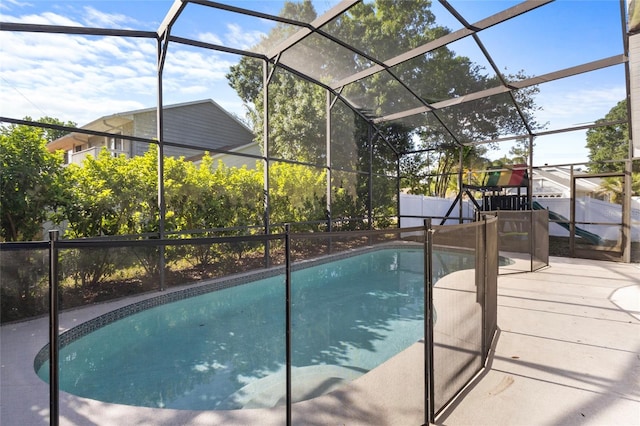 view of swimming pool with glass enclosure and a fenced in pool
