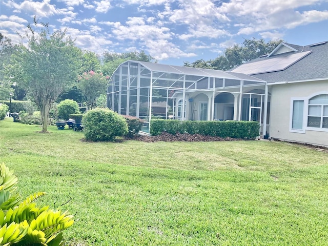 11401 Willow Stowe Ln, Windermere, FL 34786 - rear view of property featuring a lawn, stucco siding, roof with shingles, and a lanai