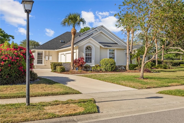 11401 Willow Stowe Ln, Windermere, FL 34786 - ranch-style house with stucco siding, a front yard, and solar panels