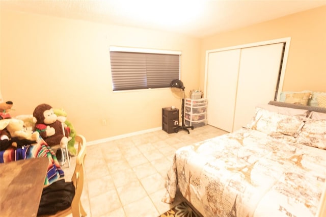 bedroom featuring a closet and baseboards