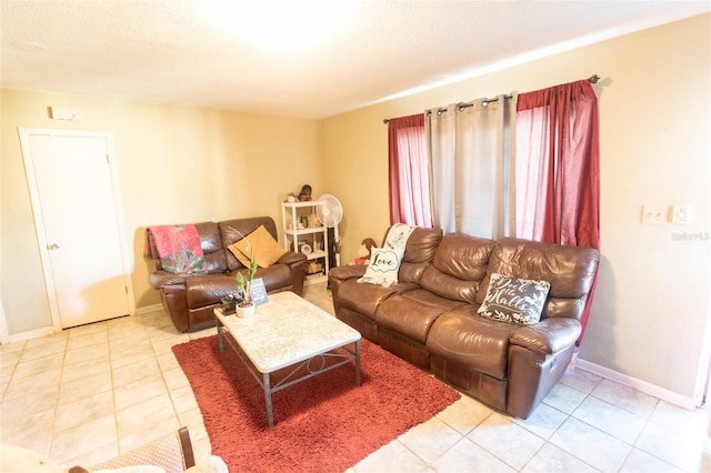 living room featuring baseboards and light tile patterned floors