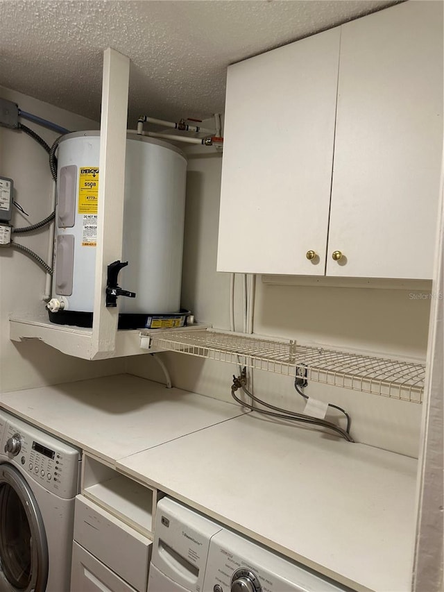 802 Park Lake Cir Unit 2, Maitland, FL 32751 - clothes washing area featuring water heater, washer / clothes dryer, a textured ceiling, and cabinet space