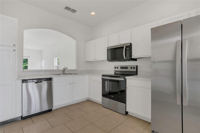 1822 Meadow Pond Way, Orlando, FL 32824 - kitchen with arched walkways, stainless steel appliances, light countertops, a sink, and visible vents