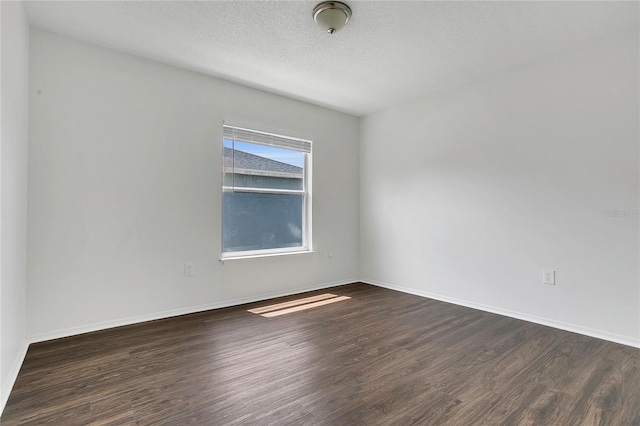 1822 Meadow Pond Way, Orlando, FL 32824 - empty room with a textured ceiling, dark wood-style flooring, and baseboards