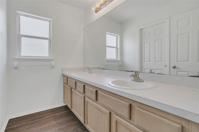 1822 Meadow Pond Way, Orlando, FL 32824 - full bathroom featuring baseboards, wood finished floors, double vanity, and a sink