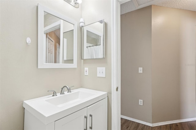 bathroom with wood finished floors and vanity