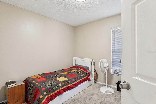 bedroom with carpet floors, a textured ceiling, and baseboards