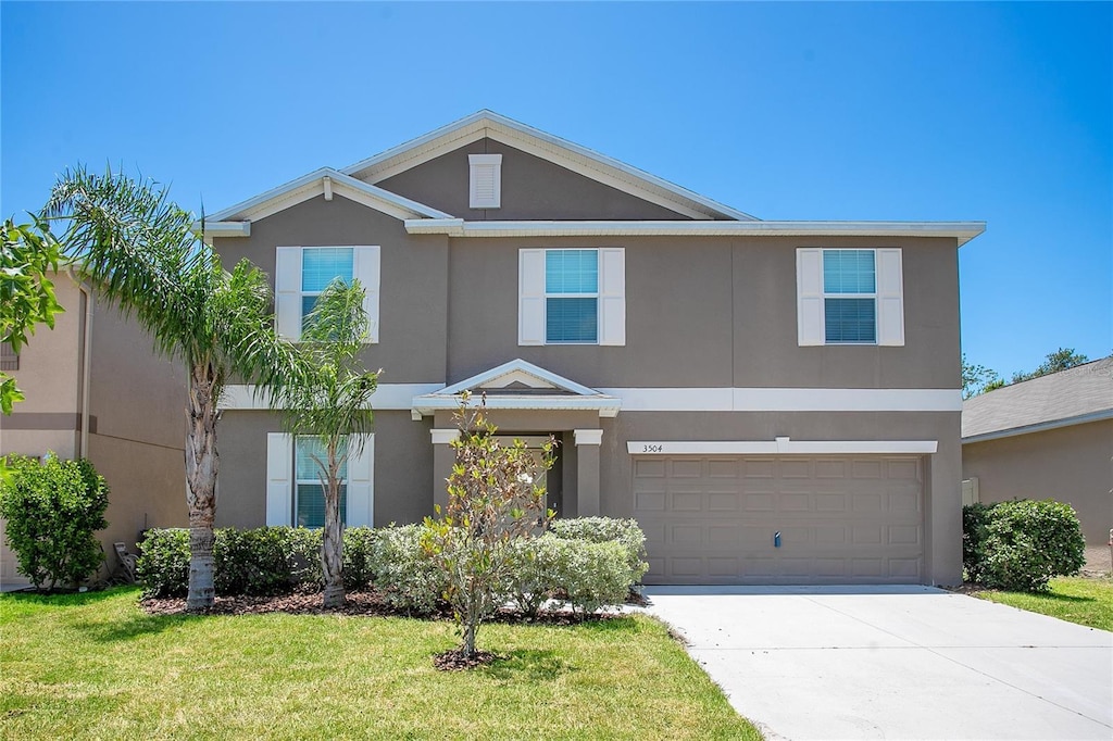 3504 Kearsney Abbey Cir, Dover, FL 33527 - view of front of house with stucco siding, driveway, a garage, and a front lawn