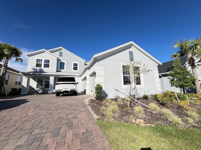 2926 Crest Wave Dr, Clermont, FL 34711 - view of front of home featuring decorative driveway and stucco siding
