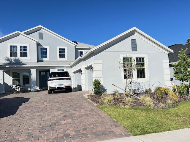 2926 Crest Wave Dr, Clermont, FL 34711 - view of front facade with stucco siding, decorative driveway, and an attached garage