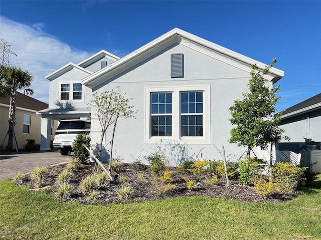 2926 Crest Wave Dr, Clermont, FL 34711 - view of home's exterior featuring stucco siding and driveway