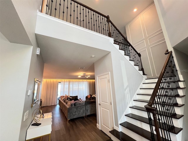 2926 Crest Wave Dr, Clermont, FL 34711 - stairway with wood finished floors, a high ceiling, and recessed lighting