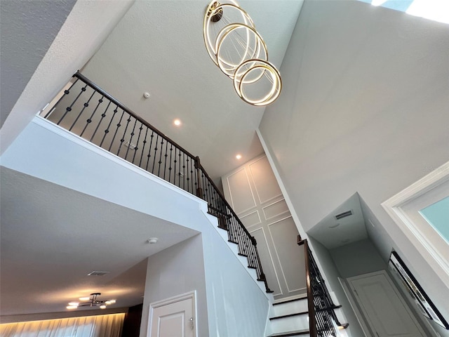 2926 Crest Wave Dr, Clermont, FL 34711 - staircase with a high ceiling and recessed lighting