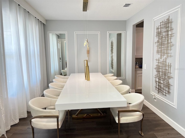 2926 Crest Wave Dr, Clermont, FL 34711 - dining area featuring dark wood-type flooring and baseboards