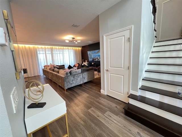 2926 Crest Wave Dr, Clermont, FL 34711 - living room with stairway, dark wood-type flooring, and a textured ceiling