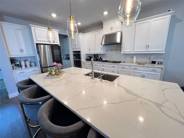 2926 Crest Wave Dr, Clermont, FL 34711 - kitchen with under cabinet range hood, a sink, stainless steel appliances, white cabinets, and decorative backsplash