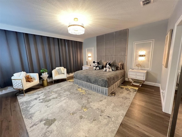 2926 Crest Wave Dr, Clermont, FL 34711 - bedroom featuring wood finished floors, baseboards, a chandelier, and a textured ceiling