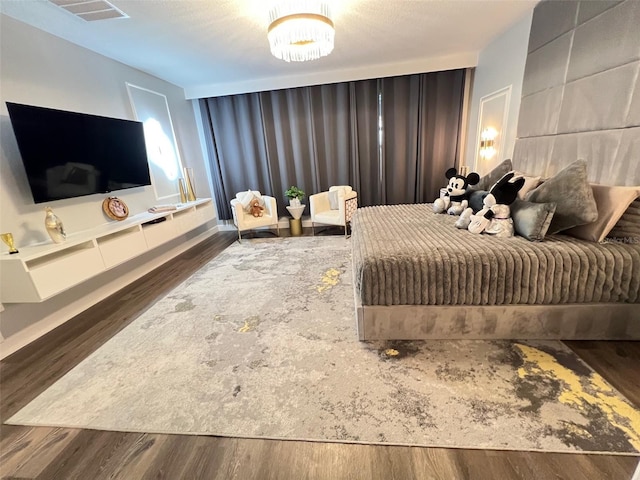 2926 Crest Wave Dr, Clermont, FL 34711 - bedroom featuring wood finished floors and a chandelier