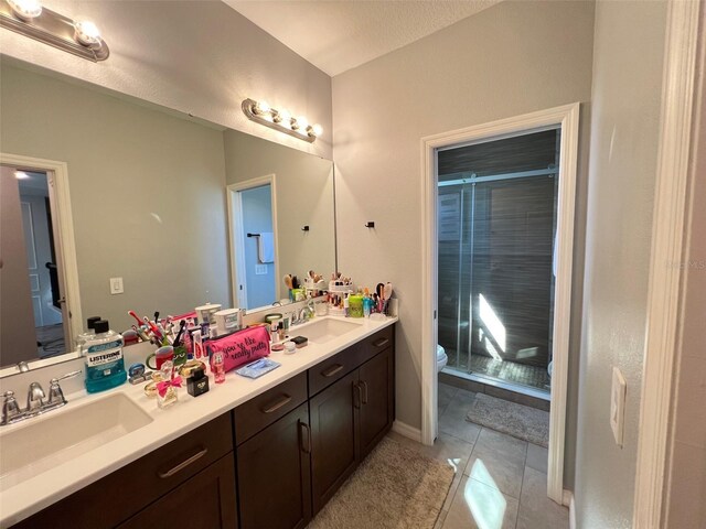 2926 Crest Wave Dr, Clermont, FL 34711 - full bath with a stall shower, toilet, tile patterned flooring, and double vanity