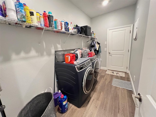 2926 Crest Wave Dr, Clermont, FL 34711 - laundry area featuring separate washer and dryer, wood finished floors, and baseboards