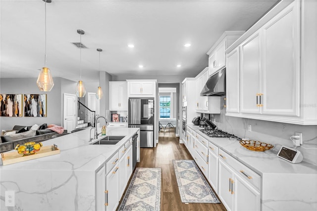 2926 Crest Wave Dr, Clermont, FL 34711 - kitchen with a sink, range hood, dark wood-style floors, white cabinetry, and recessed lighting