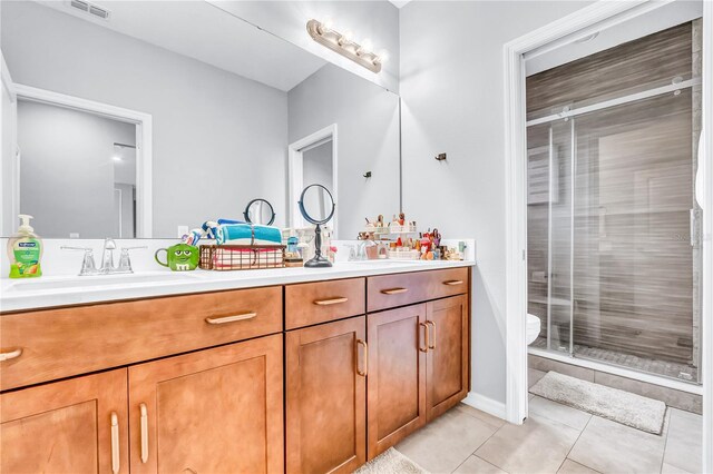 2926 Crest Wave Dr, Clermont, FL 34711 - full bath with double vanity, a stall shower, tile patterned floors, and toilet
