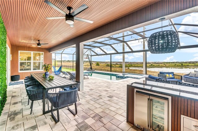 2926 Crest Wave Dr, Clermont, FL 34711 - view of patio / terrace with a ceiling fan, outdoor dining area, a pool with connected hot tub, an outdoor living space, and glass enclosure