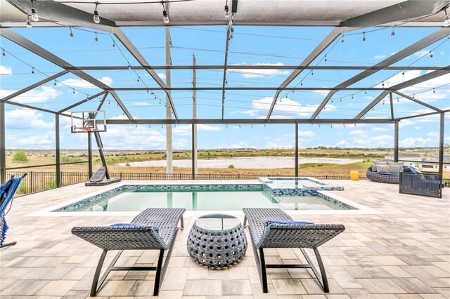 2926 Crest Wave Dr, Clermont, FL 34711 - view of swimming pool with glass enclosure, a pool with connected hot tub, and a patio area