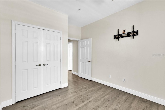 13500 Turtle Marsh Loop Unit 834, Orlando, FL 32837 - unfurnished bedroom featuring baseboards, wood finished floors, and a closet