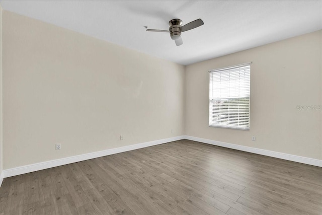 13500 Turtle Marsh Loop Unit 834, Orlando, FL 32837 - spare room featuring baseboards, a ceiling fan, and wood finished floors