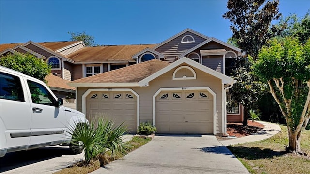 607 Northbridge Dr, Altamonte Springs, FL 32714 - view of front of house with a garage, driveway, and roof with shingles