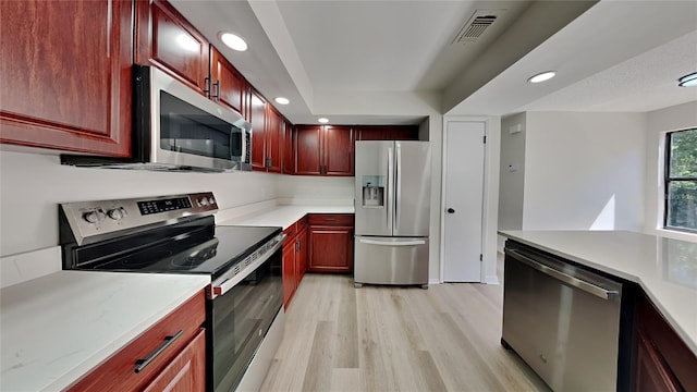 607 Northbridge Dr, Altamonte Springs, FL 32714 - kitchen featuring reddish brown cabinets, recessed lighting, appliances with stainless steel finishes, and light wood-type flooring