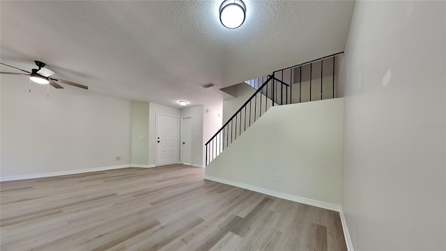 607 Northbridge Dr, Altamonte Springs, FL 32714 - unfurnished living room featuring wood finished floors, visible vents, a textured ceiling, stairs, and ceiling fan