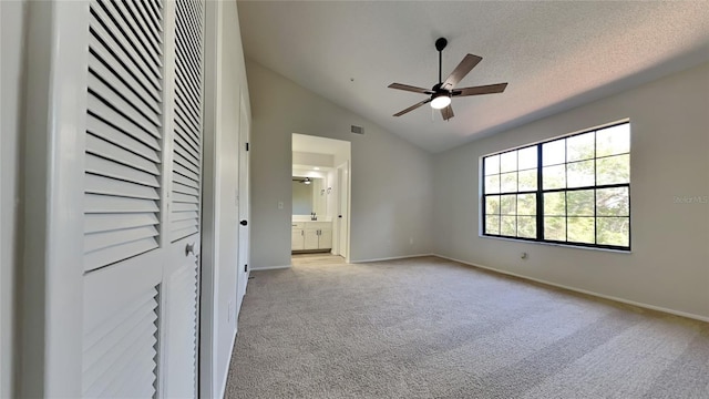 607 Northbridge Dr, Altamonte Springs, FL 32714 - unfurnished bedroom with vaulted ceiling, visible vents, baseboards, light colored carpet, and ensuite bathroom