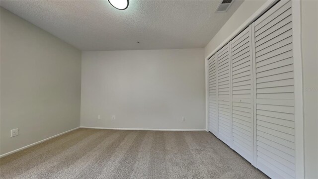 607 Northbridge Dr, Altamonte Springs, FL 32714 - unfurnished bedroom with a textured ceiling, a closet, carpet floors, baseboards, and visible vents