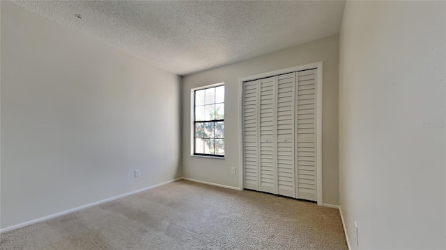 607 Northbridge Dr, Altamonte Springs, FL 32714 - unfurnished bedroom with baseboards, carpet floors, a textured ceiling, and a closet
